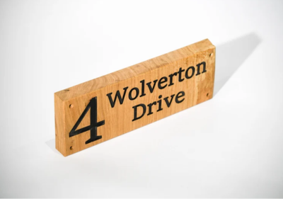 Side view of a custom engraved oak house sign by Fuscina