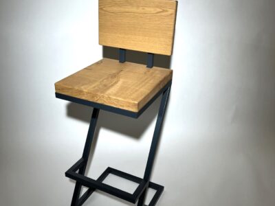 Close-up of a bespoke steel diagonal bar stool leg by Fuscina