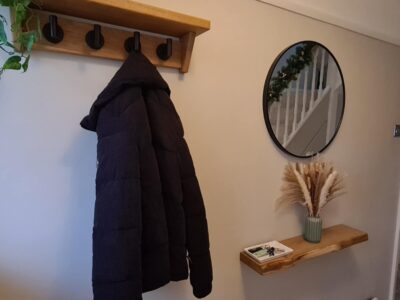 Bespoke Fuscina oak coat rack with steel hooks mounted on a wall